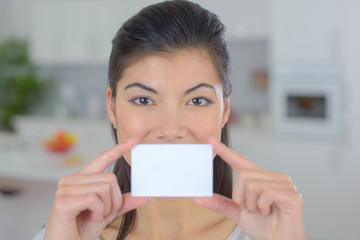 beautiful woman holding and showing empty business card