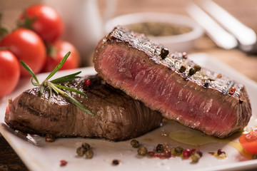 Delicious beef steak on wooden table, close-up