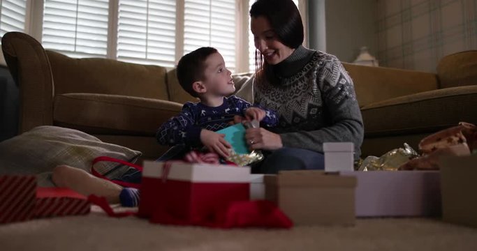 Mother and Son unwrapping Christmas gifts