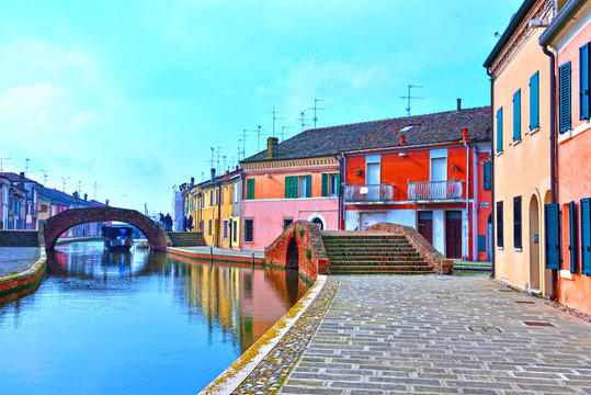Small Italian town Comacchio also known as "The Little Venice", Emilia Romagna region, province of Ferrara, Italy: Colored houses in traditional architectural style