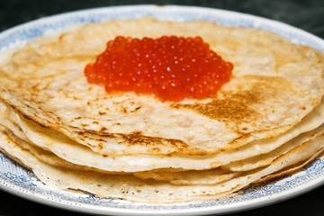 pancakes on a plate with red caviar