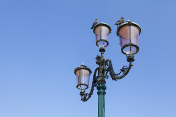 Fototapeta na wymiar Vintage street lamp against a clear sky. Venice, Italy