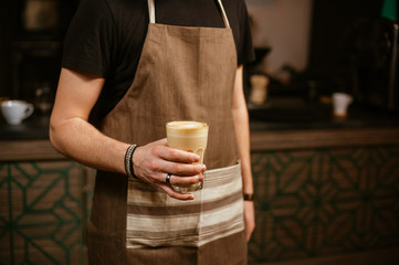 holding a cup of coffee.