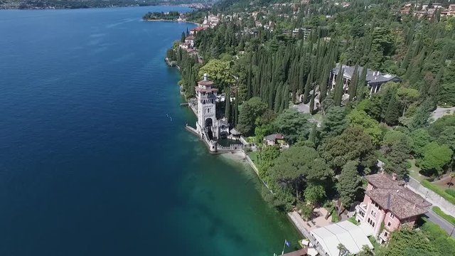 castle. Panorama of the gorgeous Lake Garda surrounded by mountains, Italy. video shooting with drone