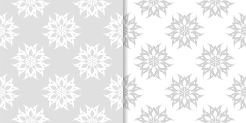 Light gray floral backgrounds. Set of seamless patterns