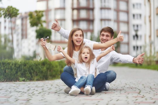 Happy Family In Front Of New Apartment Building