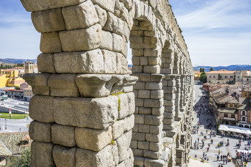 Tourism, Roman aqueduct of segovia. architectural monument declared patrimony of humanity and international interest by UNESCO. Spain - Powered by Adobe