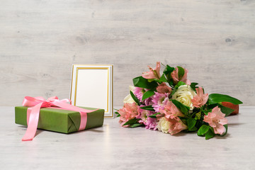 Colorful bouquet of roses, chrysanthemum and alstroemeria flowers with gift box and empty...