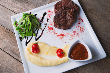 beef steak with mashed potatoes, paprika and sauce