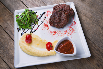 beef steak with mashed potatoes, paprika and sauce