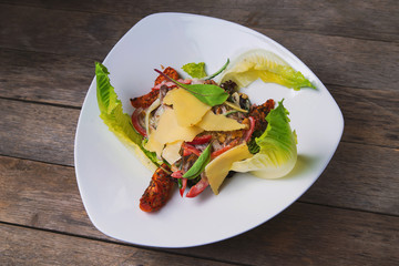 Salad of meat, vegetables, cheese and sauce