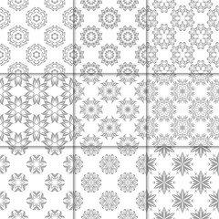 Gray and white floral ornaments. Collection of seamless patterns