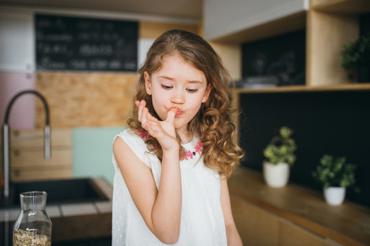 Little Girl Licking Fingers After Lunch 