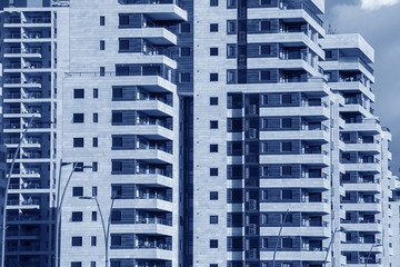 Blue Toned Modern Architecture background - generic High rise apartment building  facade.