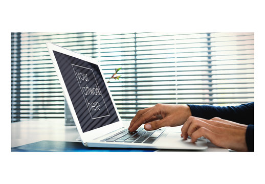 Mockup of Laptop User at Desk with Window Blinds Background