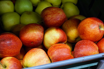 Many apples on the store counter