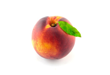 Peach with leaf isolated on white