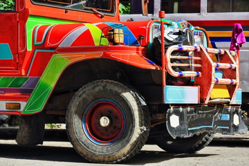 Filipino orange-red dyipni-jeepney parked at the bus station. Sagada-Mountain province-Philippines. 0238