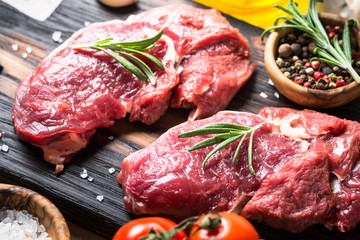 Raw beef steak rib eye with herbs.