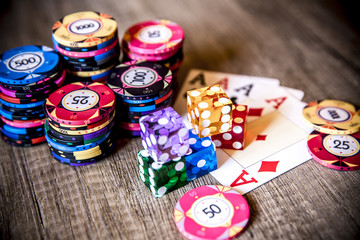 Poker chips, four aces and dice. Selective focus