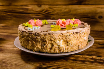 Kiev cake with cream on wooden table