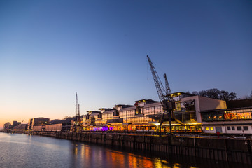 View on famous Au Quai (at Quay) area in Hamburg port next to waterfront, Grosse Elb street at dusk