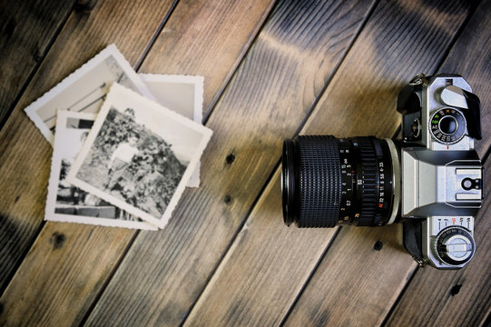 Closeup of vintage photo and film camera on antique wooden background