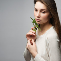 Portrait beautiful woman face portrait with green leaf , concept for skin care or organic cosmetics