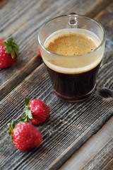 Fresh Americano coffee and strawberries on the table 