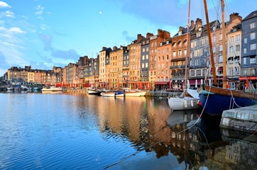 Dawn at the beautiful Honfleur harbor with boats and reflections, Normandy, France