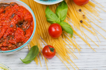 Ingredients for preparation pasta spaghetti - tomato, olive oil, spices, herbs, green olives, tomato sauce