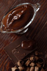 Delicious hot chocolate in glass on a brown background 