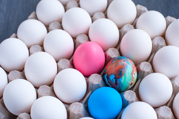 Multicolored eggs among white eggs