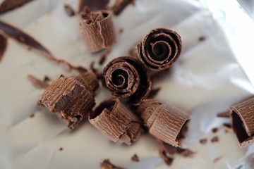 Delicious dark chocolate on the foil background  