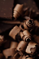 Delicious dark chocolate on a brown background