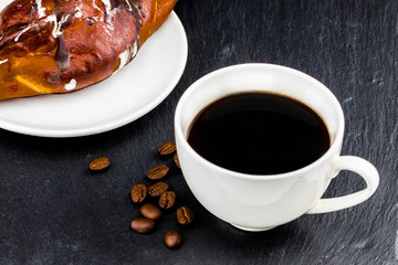 Hot coffee and pastries on a dark background