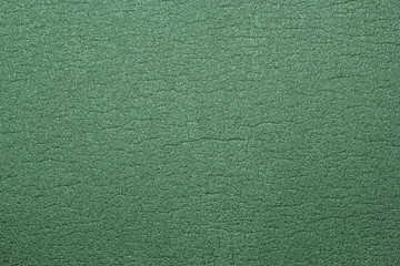 A textured green background made of foam rubber.