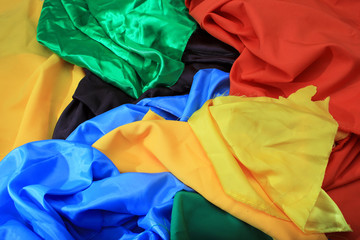 Pile of colorful silk fabrics. Crumpled patches of vibrant colors as background