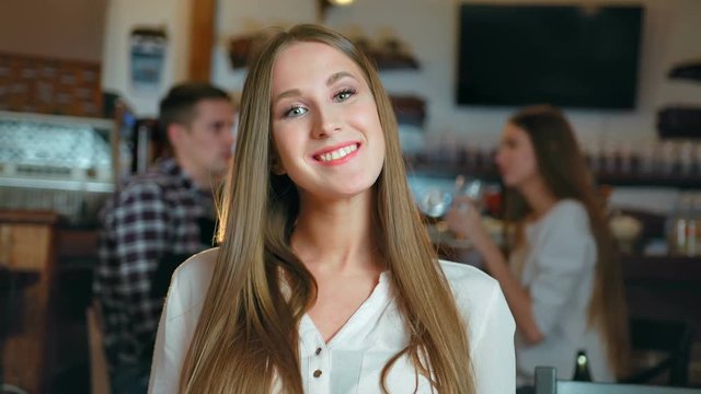 Portrait of attractive smiling young woman in restaurant