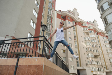 Boy hanging in the air on the buildings background
