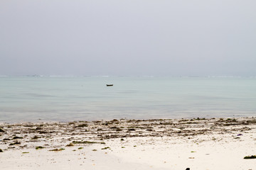 Fototapeta na wymiar Landscape with sparkling blue water off the white beaches of the Indian Ocean spice island of Zanzibar (Unguja), Tanzania