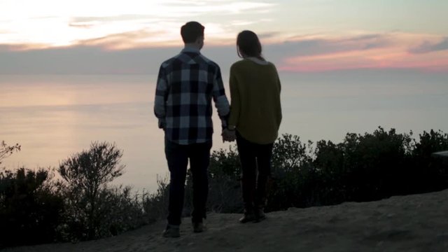 Man and Woman Enjoying Ocean Sunset 01