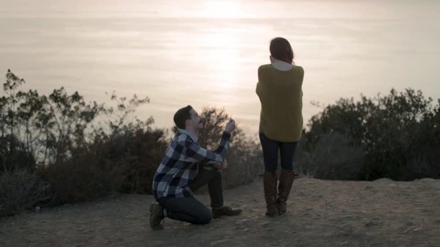 Man Proposes to Woman at Sunset