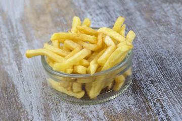 bowl of french fries on wooden backgroung background