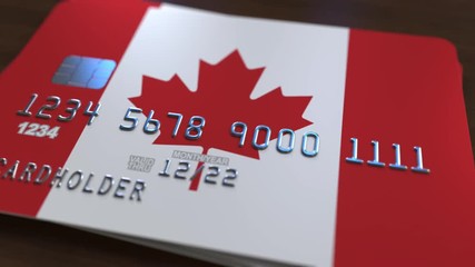 Plastic bank card featuring flag of Canada. National banking system related animation - Powered by Adobe