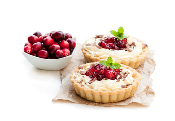Delicious  tarts with cream and fresh cranberry isolated on white. Christmas dessert.
