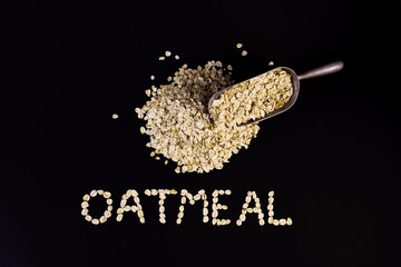Oatmeal on a black background seeds from above