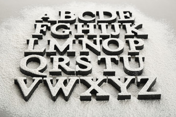 Alphabet letters on scattered flour