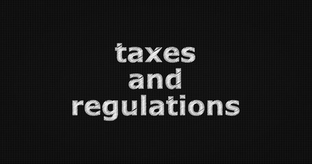 Taxes and regulations word on grey background.