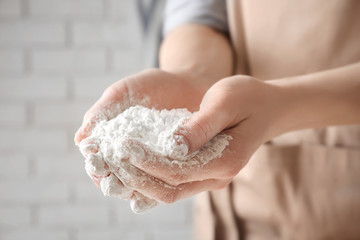 Woman holding wheat flour, closeup